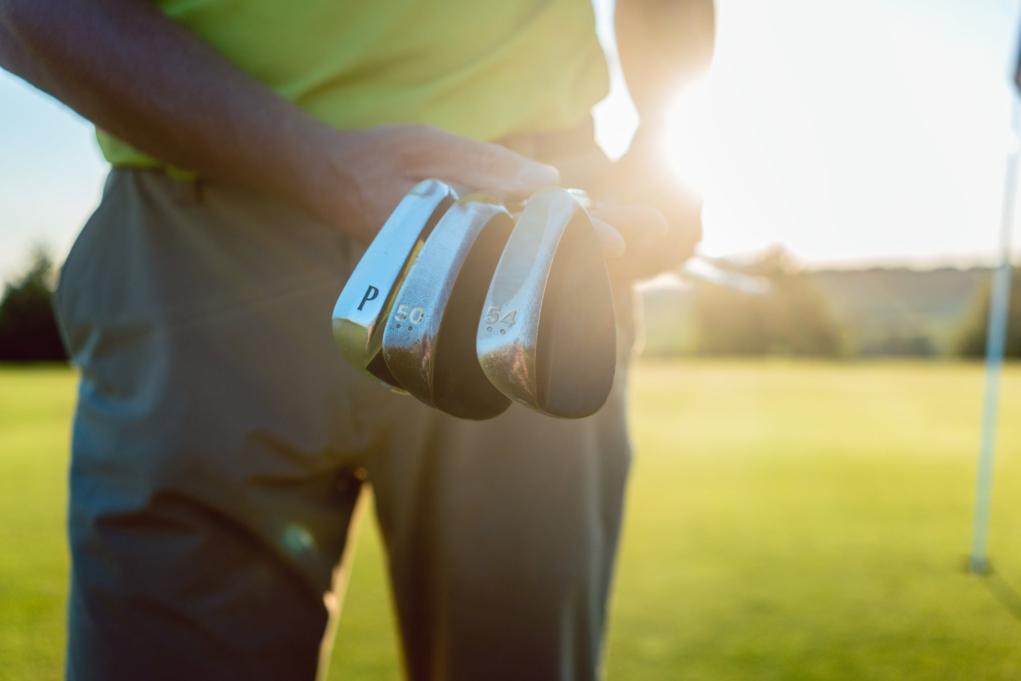 Close-up of a golfer's hands gripping a club, illustrating the split-hands drill