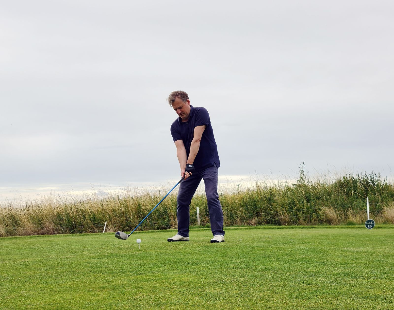 A golfer on a lush green golf course, illustrating the newly released LPGA 2027 schedule of 33 events, bigger purses and new venues